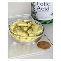 Thumbnail for A small glass bowl of yellow capsules is next to a coin for size comparison, with a Swanson Folic Acid - 800 mcg 250 capsules bottle, essential for pregnancy health and rich in vitamin B9, in the background.