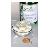 Thumbnail for A bottle of Swanson Magnesium Lactate - 84 mg 120 capsules stands in the background, with a penny nearby and a bowl of white capsules on a glass surface, emphasizing its support for bone health.