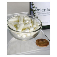 Thumbnail for A bowl of white capsules sits beside a US penny for scale, with a Swanson Selenium L-Selenomethionine 100 mcg 200 Capsules bottle in the background, emphasizing its immune support and enhanced bioavailability.