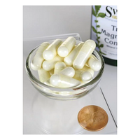 Thumbnail for A bowl of white capsules sits beside a penny for size reference, with the 