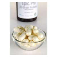 Thumbnail for In the foreground, a glass bowl holds white capsules, implying they are Swanson's Epic Pro 25-Strain Probiotic in veggie embo capsules, with a blurred bottle seen in the background.