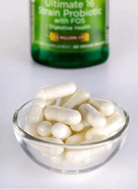 Thumbnail for A small glass bowl of white capsules sits in front of a green bottle labeled 