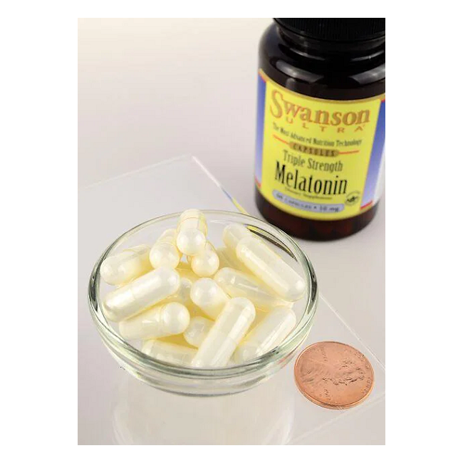 A small bowl of white capsules sits beside a Swanson "Melatonin 10 mg 60 Capsules - Triple Strength" bottle, illustrating its sleep-enhancing role with a penny for scale. Ideal for conquering jet lag or ensuring restful nights.