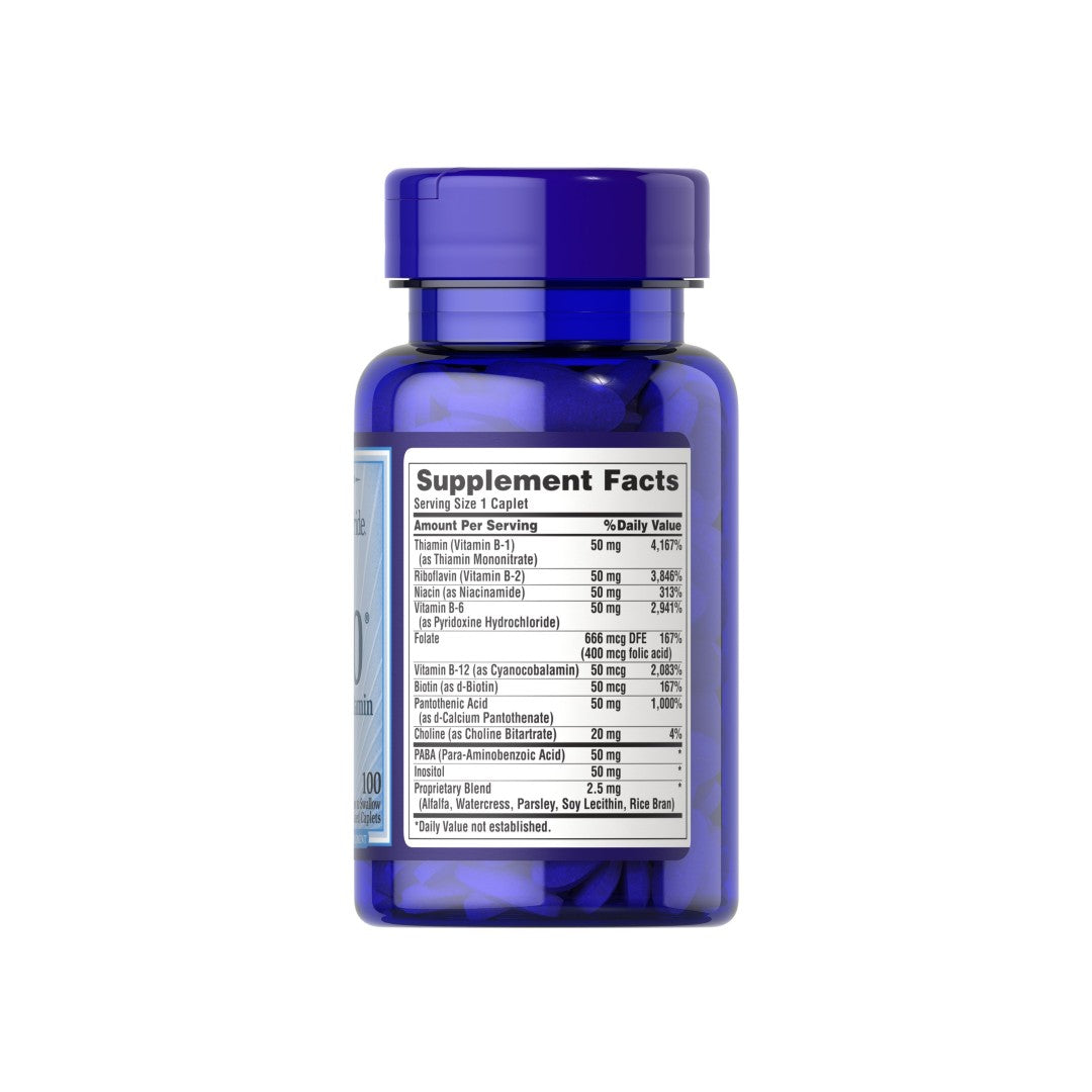 A bottle of Puritan's Pride Vitamin B-50 Complex 100 Coated Caplets with a label promoting cardiovascular health.