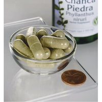 Miniatura per Un flacone di Chanca Piedra di Swanson- 500 mg 60 capsule vegetali in una ciotola di vetro.