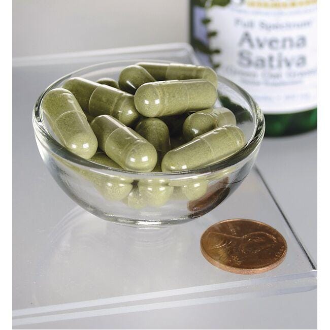 Una ciotola di Swanson Avena Sativa - 400 mg 60 capsule accanto a una bottiglia di olio d'oliva.