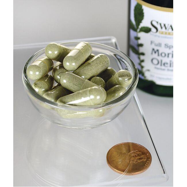 SwansonMoringa Oleifera - 400 mg 60 capsule in una ciotola accanto a una bottiglia di Moringa Oleifera di Swanson, evidenziando i benefici della riduzione dello stress ossidativo e del danno cellulare.