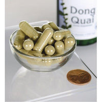 Miniatura di Swanson Dong Quai - 530 mg 100 capsule in una ciotola accanto a una bottiglia.