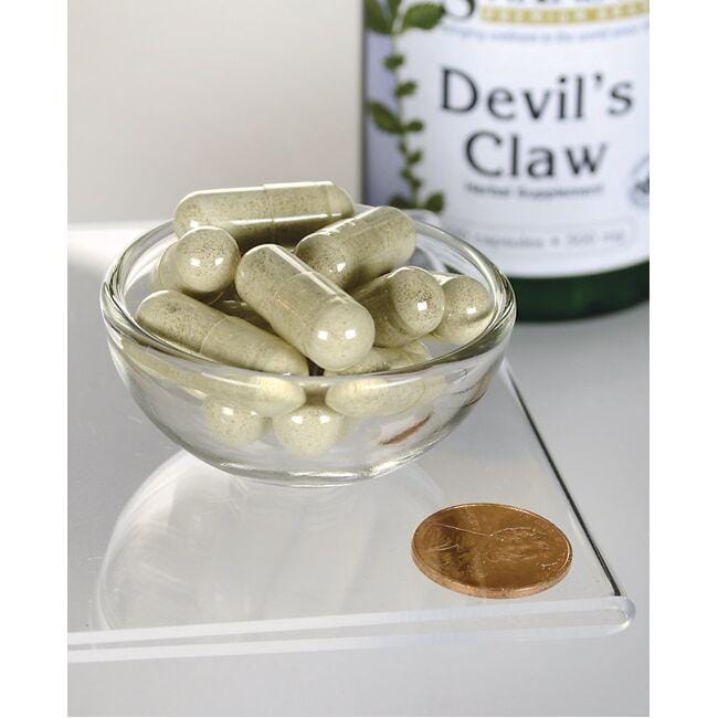 SwansonArtiglio del Diavolo - 500 mg 100 capsule in una ciotola con una moneta.