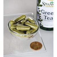 Miniatura di un flacone di Tè verde Swanson - 500 mg 100 capsule con accanto un centesimo.