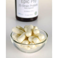 Una ciotola di pillole bianche accanto a un flacone di Epic Pro 25-Strain Probiotic di Swanson- 30 capsule vegetali.