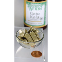 Miniatura per Un flacone di Swanson Gotu Kola Extract - 100 mg 120 capsule si trova accanto a una ciotola.