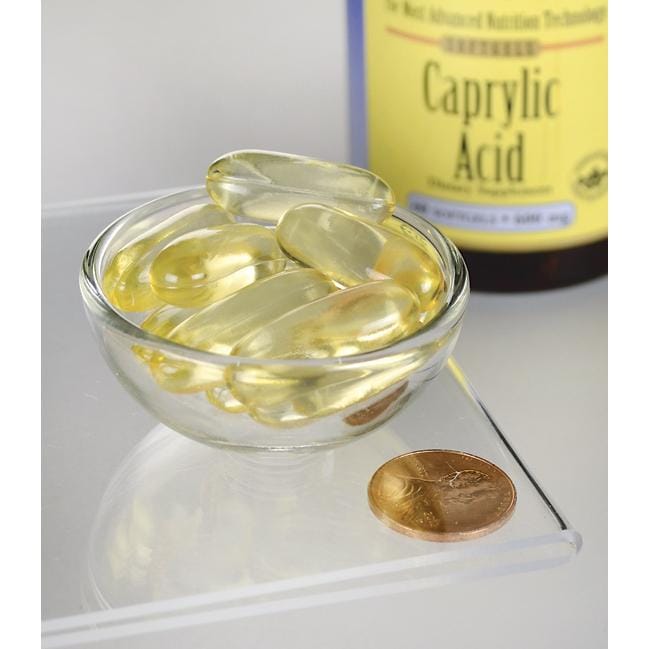 SwansonAcido caprilico - 600 mg 60 capsule softgel in una ciotola accanto a una moneta.