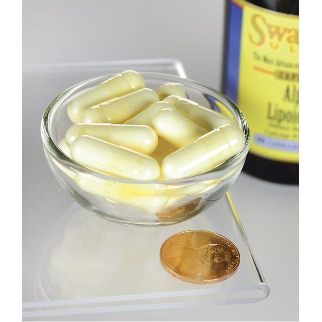 Una ciotola di Acido alfa lipoico Swanson - 300 mg 60 capsule con accanto una moneta.