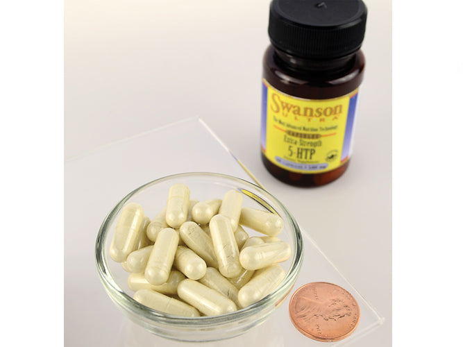 Un flacone di 5-HTP Extra Strength di Swanson- 100 mg 60 capsule accanto a un centesimo.